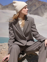 a woman in grey blazer